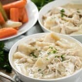 Two white bowls of Chicken and Dumplings