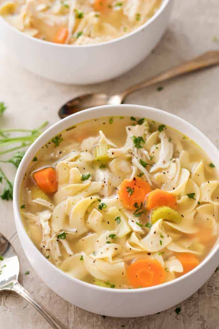 Crockpot chicken noodle soup in white bowl