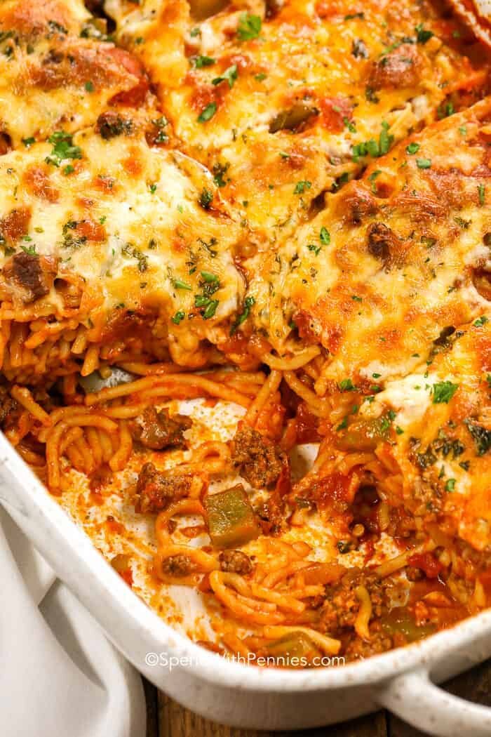 Baking dish full of Baked Spaghetti with serving taken out of it