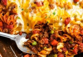 a casserole dish of baked hamburger casserole with a spoon