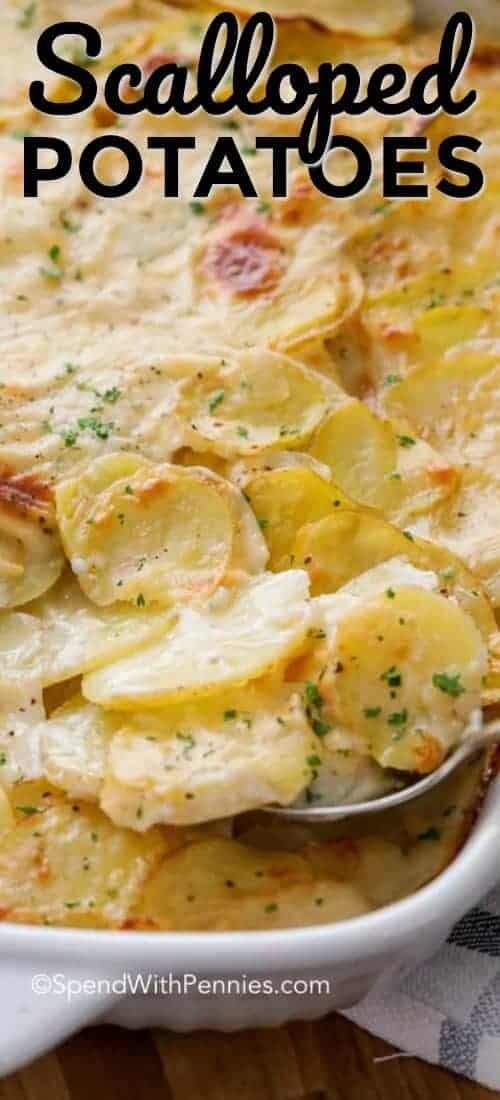 A pan of baked scalloped potatoes being served shown with a title