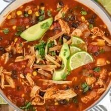 a pot of chicken tortilla soup garnished with lime