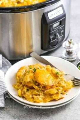 a plate filled with crock pot scalloped potatoes