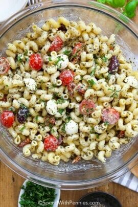 A large bowl of pesto pasta salad