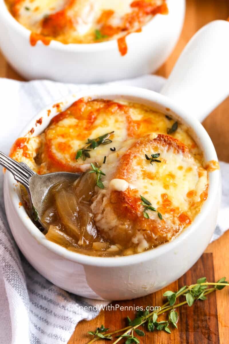 a bowl of French onion soup with a spoon