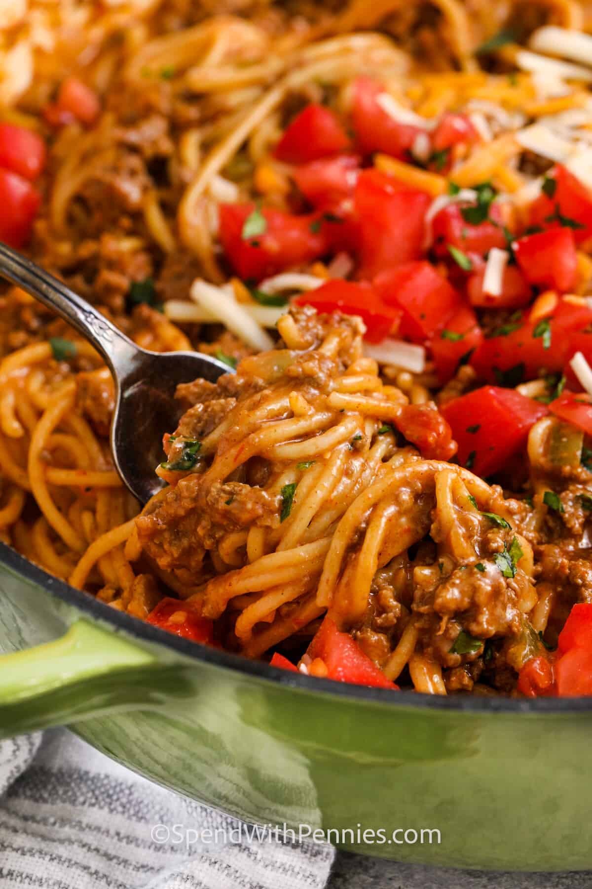 taking a forkful of Taco Spaghetti out of the pan