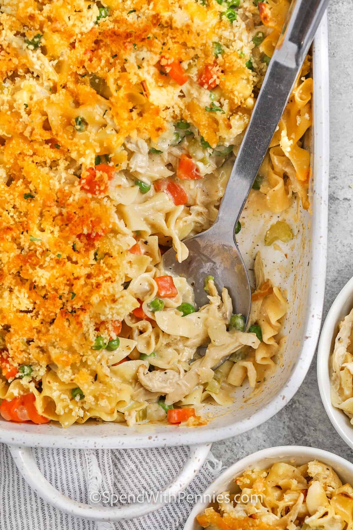 Chicken Noodle Casserole in the casserole dish with a spoon